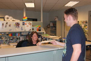Counselor gives a student  the AP waiver so he can apply for the test fee reduction.