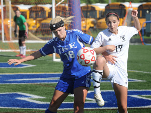 Junior Paige Duda fights for the ball against a Grand Blanc player in a regional championship game.