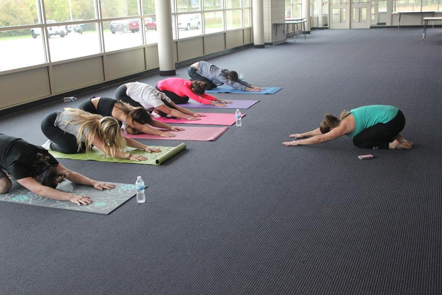 Yoga club members practiced the child’s pose position. “Child’s pose relaxes me and lets me prepare myself for the next pose; it is awesome,” yoga club member junior Brandon Tomayko said. Members enjoy this position during each meeting.
