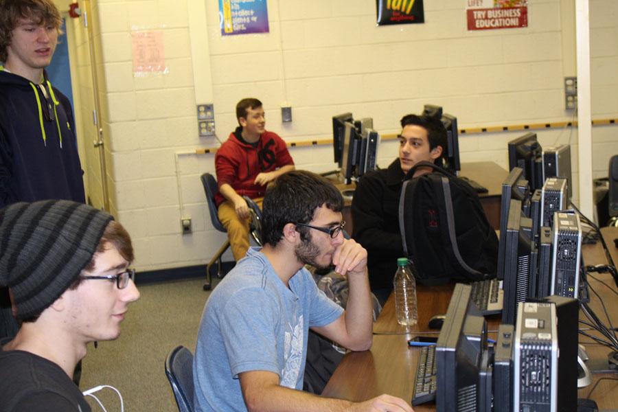 Computer club president Bryce DeJausserand helps members access the club web site to create profiles and screen names.