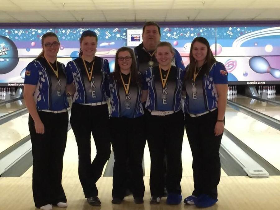The Girls Bowling team stands with their coach following a match.