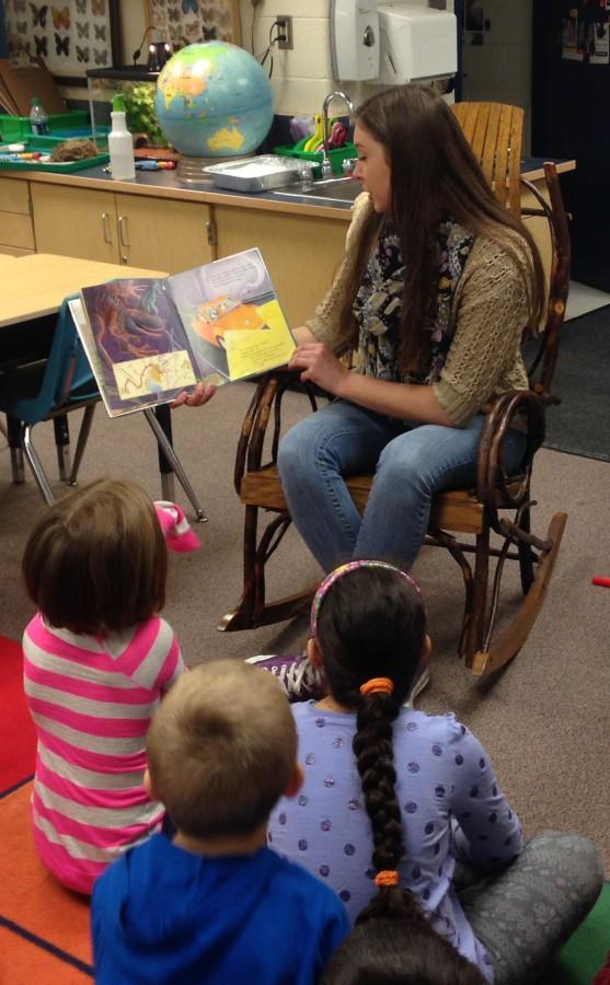 Senior future educators student Katie Johnson reads a book to her young learners at Roberts Elementary School. “I really like working with the first grade, because it helps me decide my future plans and I always love, at the end of the class, when they all rush to do the ‘first grade stampede’ and hug me,” Johnson said.
