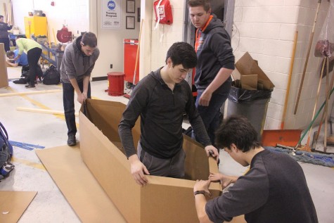 Seniors Cameron Nolff, Jacob Peck, Dominic Rende and Brandon VanOphem work on their boat