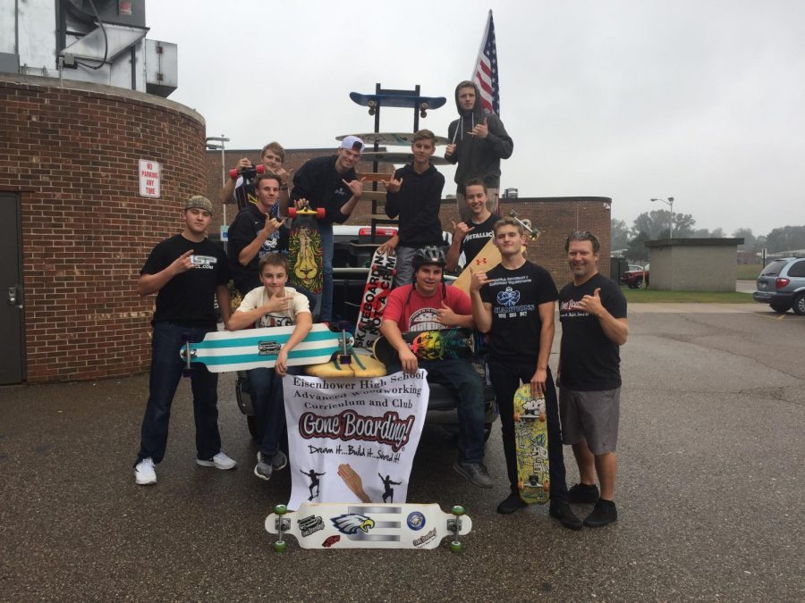 Gone Boarding students and instructor show off their boards before they shred during the Homecoming parade.