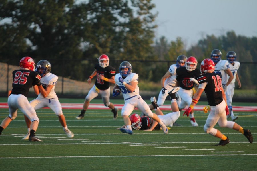 The Varsity football team plays against Romeo High School on Sept. 14. The team lost 14-21.