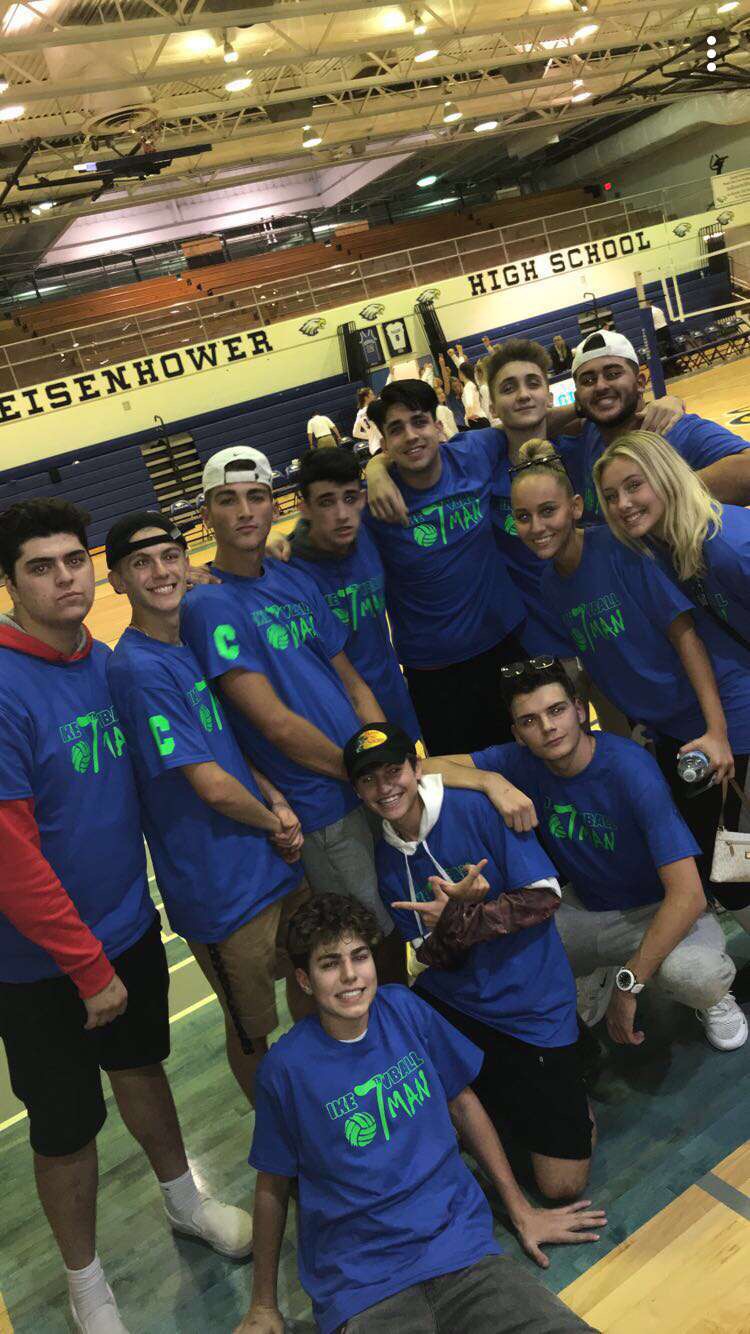 The God Squad wears their matching t-shirts to supporting the women’s volleyball team at a home volleyball game.