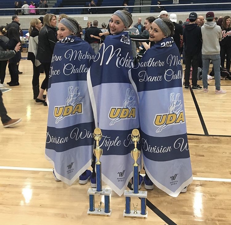 Kayleigh Messina, right, at the UDA Southern Michigan Regional competition alongside teammates Emma Leykauf, left, and Emma Seaglund, center.