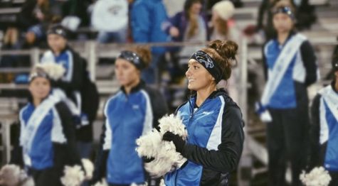 Diana Silveri and her team cheering for the varsity football team in the fall.