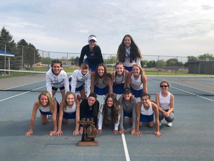 Womens varsity tennis team happy after winning their regional and advancing to States.