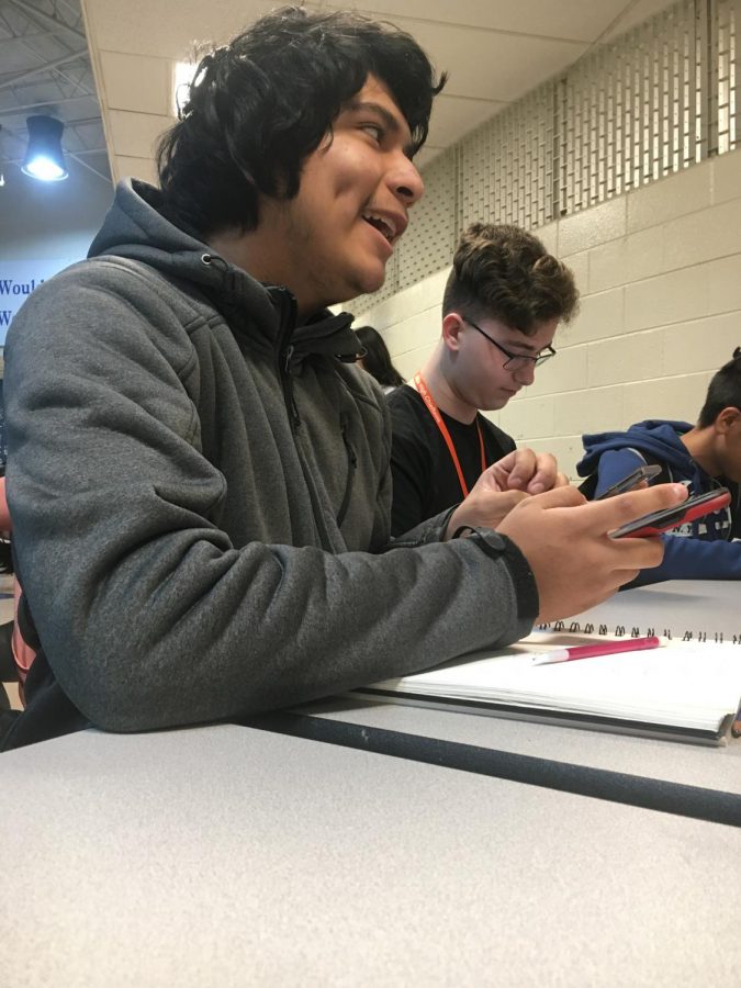 Before the morning bell rings, sophomore Axel Garcia sits and chats with his friends while drawing. Garcia disliked his day at school, but after spending time with his favorite people, his day improved. Seeing my friends and bagel day are the only things that make me feel happy, Garcia said.