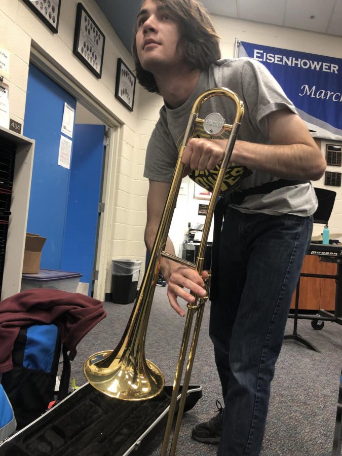 As+students+go+outside+for+marching+band%2C+sophomore+Ethan+Gastmeier+removes+his+trombone+from+its+case+and+assembles+it.+%E2%80%9CI%E2%80%99ve+strengthened+the+connections+I+have+in+band%2C%E2%80%9D+Gastmeier+said.+It+was+his+fourth+year+in+the+band+program%2C+along+with+many+of+his+peers.