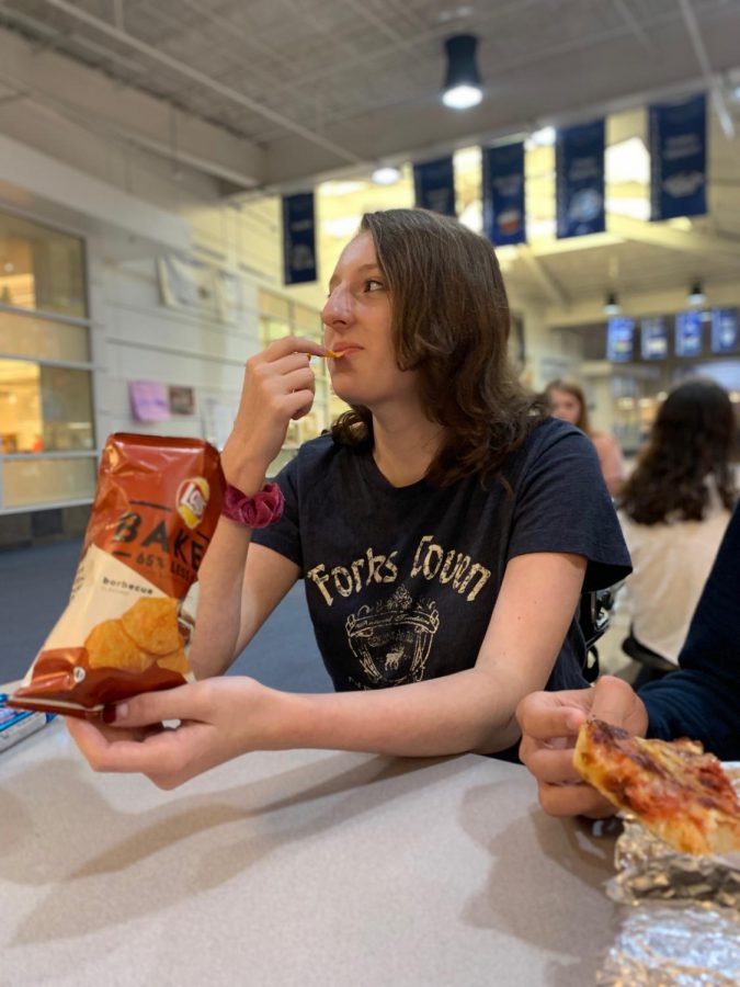 Eating his lunch, sophomore Evan Shallow talks with friend Riley Demond at B lunch. “I was very happy; I sit with her every day,” Shallow said. He went back to his conversation with Demond.