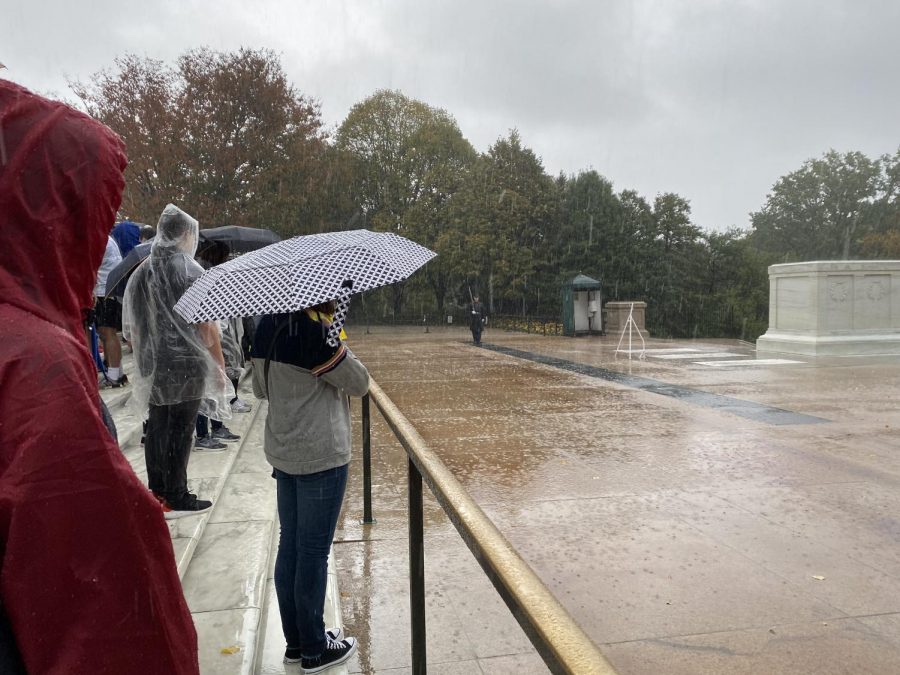 Standing+in+the+rain%2C+sophomore+Madailein+Elton+watches+the+Changing+of+the+Guard+ceremony+at+the+Tomb+of+the+Unknown+Soldier.+%E2%80%9CWe+went+to+see+the+changing+of+the+guard+and+it+absolutely+just+started+pouring.+We+all+got+completely+soaked%3B+that+was+an+experience%2C%E2%80%9D+Elton+said.+Students+returned+to+the+hotel+and+changed+out+of+their+wet+clothes+before+continuing+on+to+see+the+White+House+and+Newseum.+