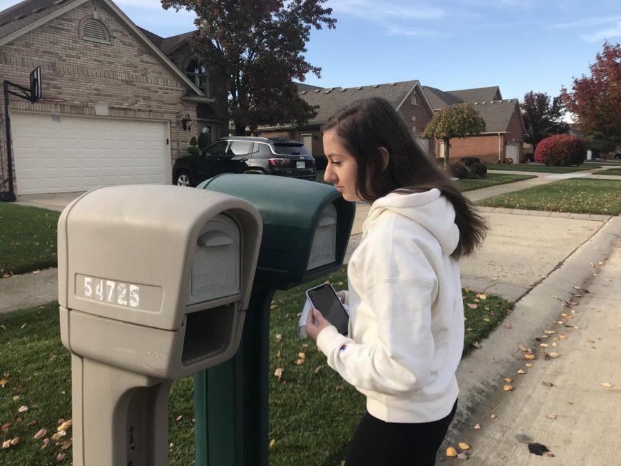 Sophomore Amela Halkic puts Toys for Tots bottle drive fliers on mail boxes. “I think it’s a great way to help out kids that are in need,” Halkic said. As a member of Student Council, she tried to get publicity for the council’s upcoming bottle drives for Toys for Tots.