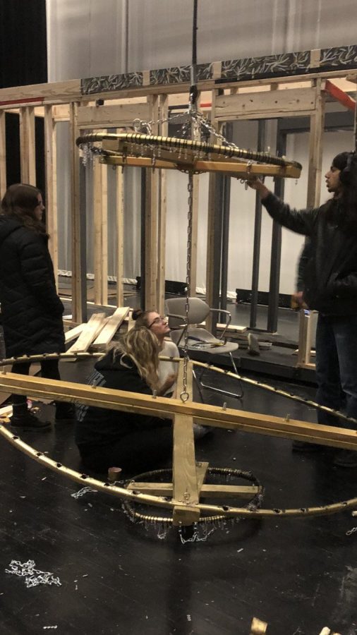 Engulfed in their work, seniors Isabel Hafner, Satbir Mangat, Anna Schimdt and Samantha Ludwig create the chandelier for the show. “I think that it is why I ended up getting into stagecraft and the theater aspect of the school in general. And I taught myself a bunch of other aspects I use to build.” Mangat said. They spent their time since September producing the stage for the show. 
