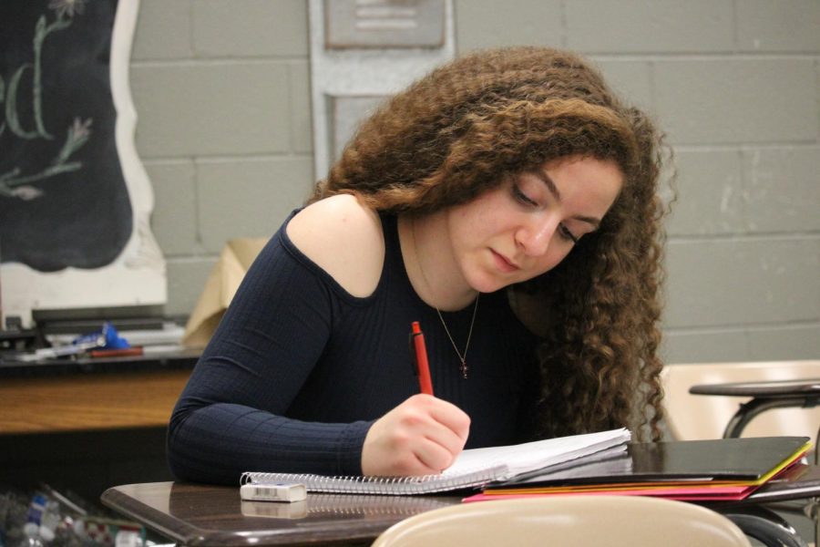 Focusing on taking notes, junior Lucia Mancini writes notes to study from. “Im intense and ambitious, especially just because I expect so much of myself,” Mancini said. “Im constantly studying making sure I understand stuff and if I dont, I work on it until I can.” Mancini studied a lot for the upcoming exams.