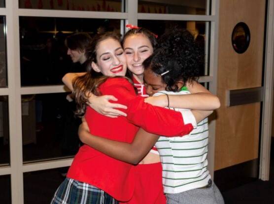 As she finishes up the last show of “High School Musical: On Stage,” junior Olivia Steele shares a hug with her two friends, junior Sydney Townsend and junior Carly Irwin. ”I have family relations with a lot of them [Ike students], so I was able to connect deeper with a lot of them individually,” Steele said. Steele realized even though she loved her private school, her public school changed her life for the better.
