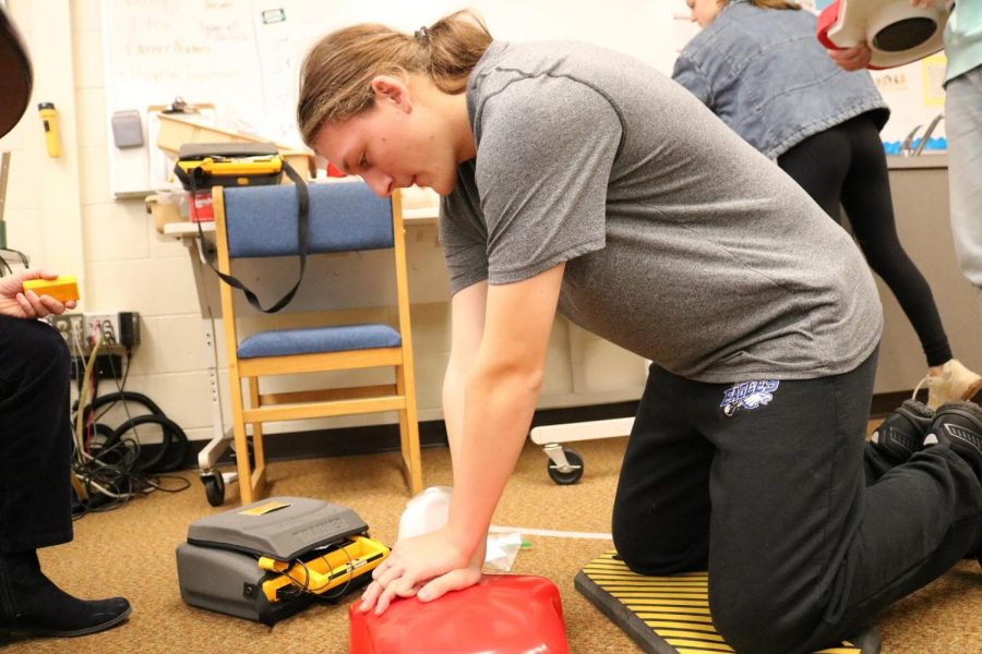 Showcasing lifesaving CPR, junior Peter Snider gets tested for certification. “If the situation were to arise, I can perform basic CPR on a person in need,” he said. Every student physically able to get certified went through testing. 