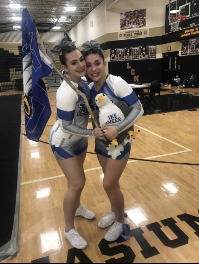 After competing, junior Abby Rossow and former Eisenhower cheerleader Marialisa Sugameli were all smiles at the Lanse Creuse North competition. This is Rossows third year cheering for Eisenhower. “Im excited to finally be back with a new team and new teammates,  Rossow said. 