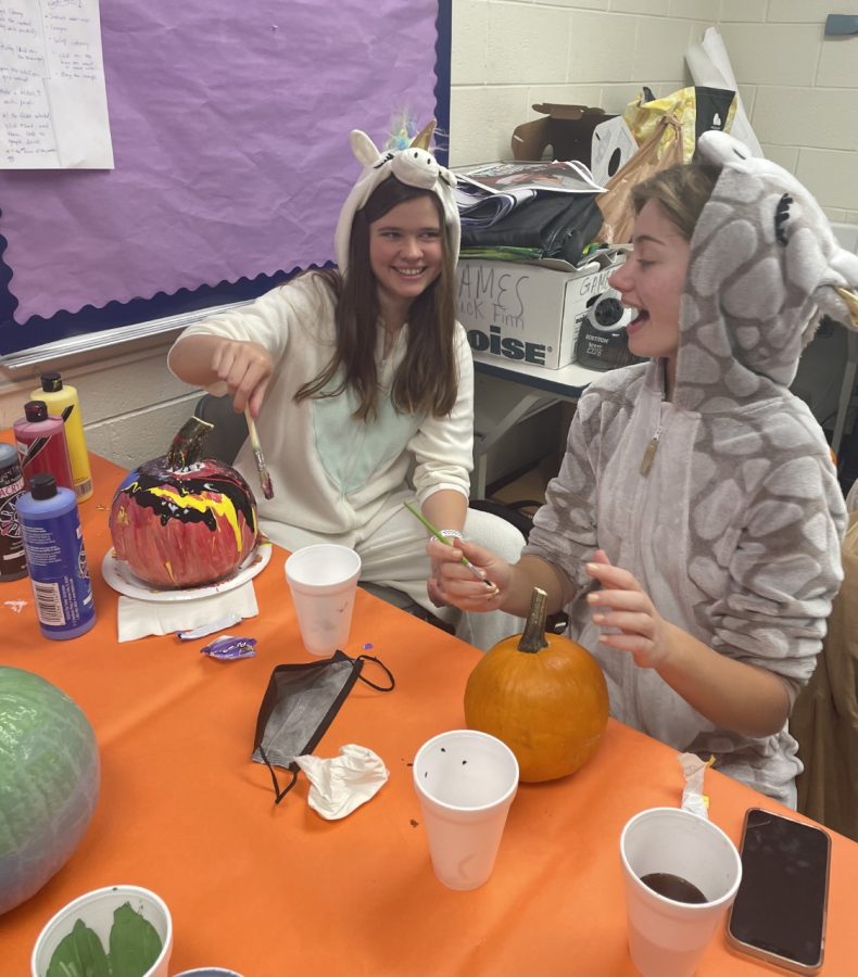 Painting their pumpkins, Co-Editor-in Chiefs Lauren Devereux and Danielle Carlisi laugh during their halloween party in room 640. The party took place on Friday, October 29th and after decorating their pumpkins, a pumpkin contest was held.  “I was just really excited to have a relaxing day after putting in a lot of work the past few weeks to get our last edition out,” Carlisi said.