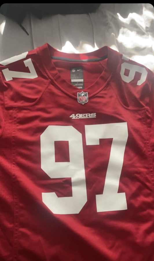 Senior Julius Korkis shows off his 49ers jersey of player Nick Bosa.
