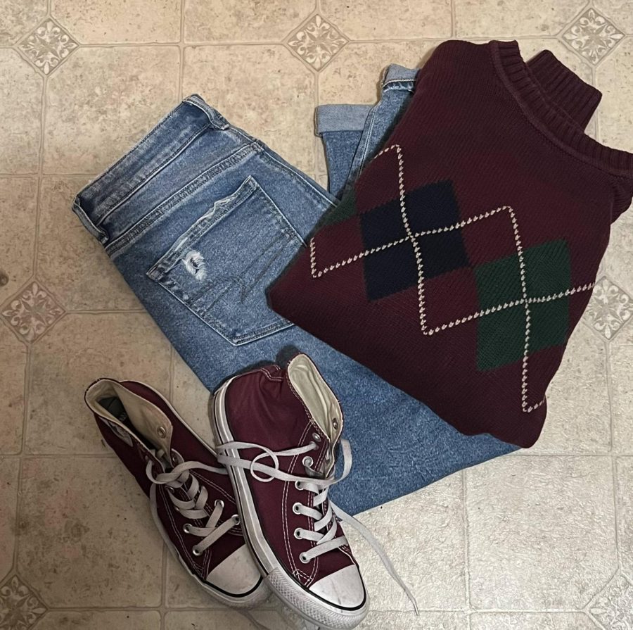 When styling clothes Mady Robson paired blue mom jeans with a patterned sweater and maroon converse. I love this outfit, said sister Robson.  Its super comfortable and trendy.
