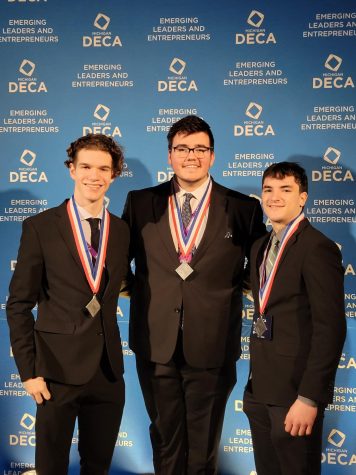 Robert Hilliard, Robert Thompson and Jonathan show off their efforts at the International Career Development Conference. “I felt gratified because we put a lot of work into it,” senior Jonathan Kotas said. They will compete at Nationals at the end of April.