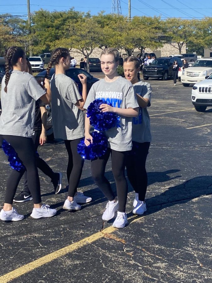 Dancing through the decades. Preparing for the Eisenhower parade, sophomore Peyton Holman marches with the rest of the varsity dance team. Holman got ready to walk from Dairy Queen to Eisenhower to participate in the homecoming festivities. “I thought it was fun that the community came together,” Holman said