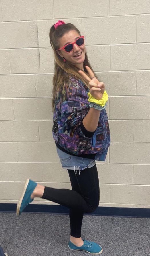 Getting Groovy. Striking a pose, sophomore Zoe Mielke dresses up for 80s spirit day. “I got the inspiration and outfits from my mom.” Mielke said. Mielke dressed up for each day of the spirit week, including the homecoming game and dance.