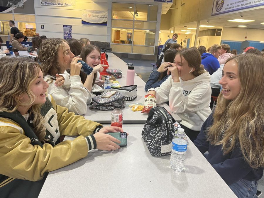 At lunch in her 90’s day apparel, sophomore Riley Quirk talks with friends. Quirk loved the decades theme because she enjoyed the styles that were popular at the time. “I enjoyed dressing up for the 70s, 80’s, and 90’s day because I love the clothing from those times,” Quirk said.