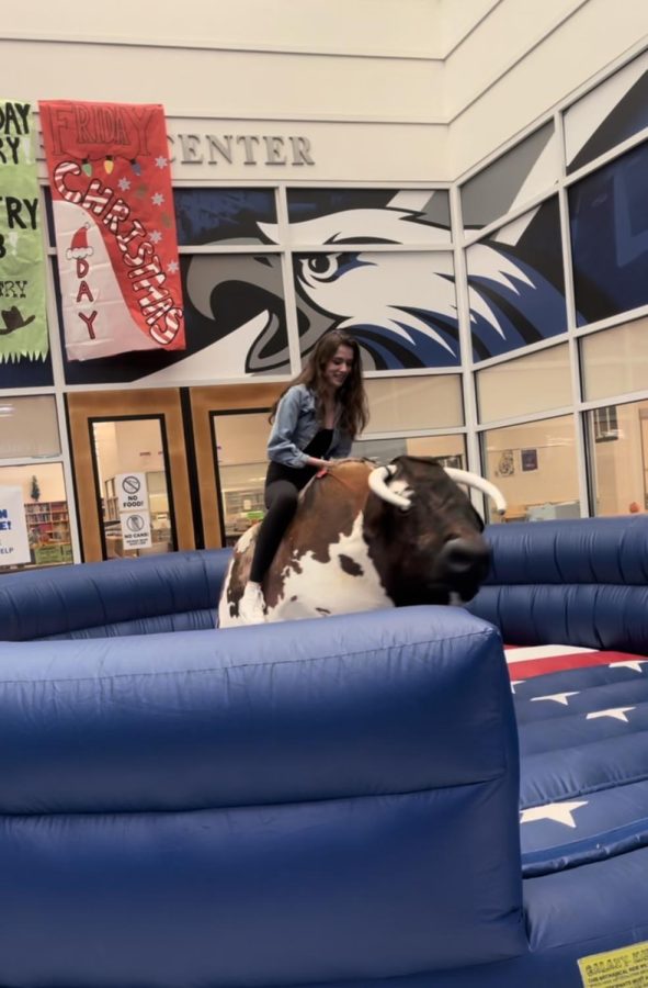 On+November+3rd%2C+Senior+Isabella+Demaj+rode+a+mechanical+bull+that+the+student+council+brought+in+for+all+lunch+hours.+Demaj+lasted+15+seconds+before+being+swung+off+onto+the+inflatable+barrier.+%E2%80%9CIt+was+a+lot+of+fun%2C%E2%80%9D+Demaj+said.+%E2%80%9CI+was+super+nervous+before+doing+it+but+once+I+finished+I+wanted+to+go+on+again.%E2%80%9D%0A