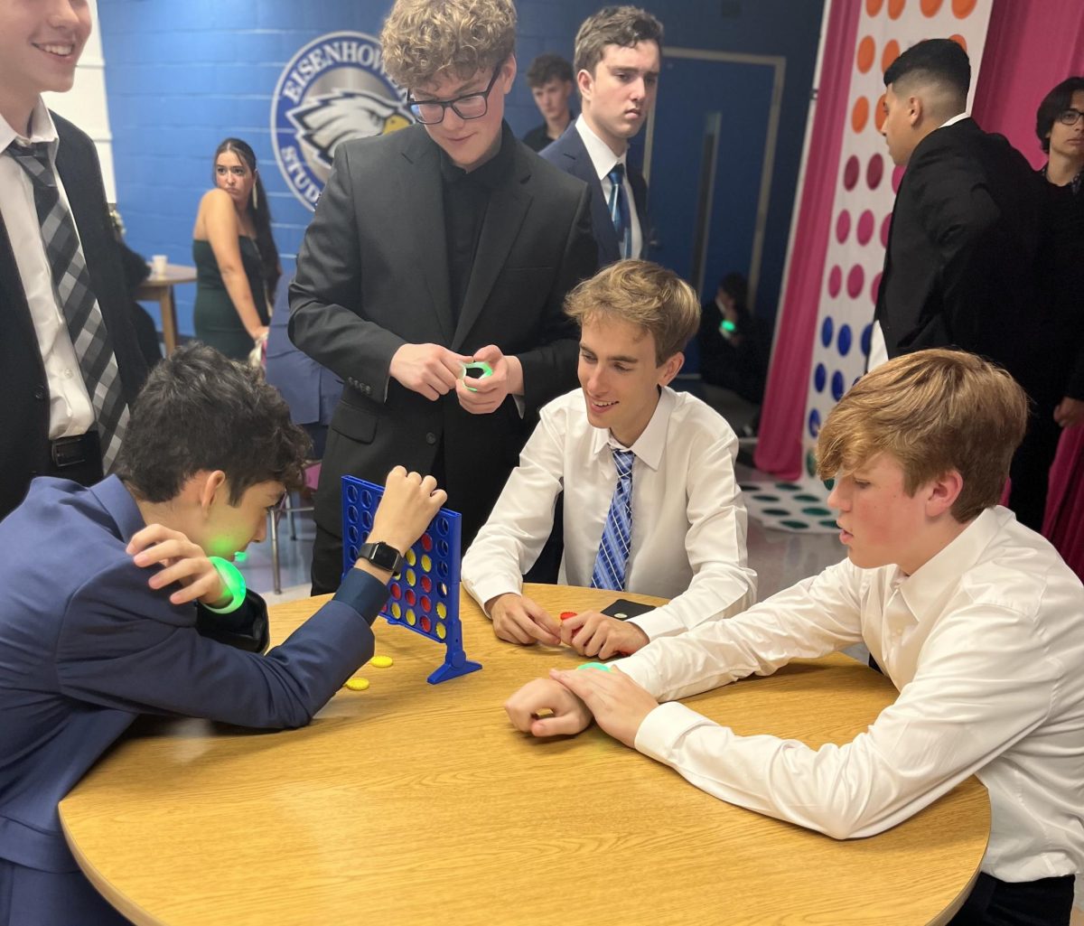 Connecting with connect 4. Stood in front of a game table, senior Cole Weinert watches his friends play connect 4. At the homecoming dance, Weinert spent time with his friends before they all went their separate ways. “I like spending quality time with everyone before life moves on,” Weinert said. 