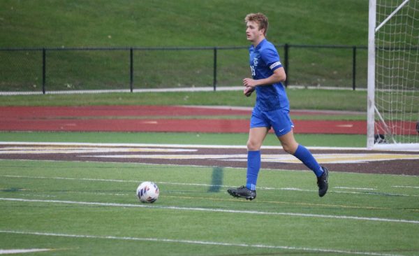 Semi-Finals success. Senior center back Devin Chene chases after the ball. The team won against Stoney Creek High School 5-0.