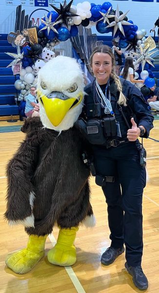 Taking on school. The new SRO, Lauren Weiss,  takes a picture in the gym with the Eagles mascot. Officer Weiss has spent years following in her fathers footsteps. “Honestly [to gain from this experience], I just want to build connections and relationships and just be there for students as a guidance person or someone that you can come to, to help them through whatever they may be going through,” Weiss said.
