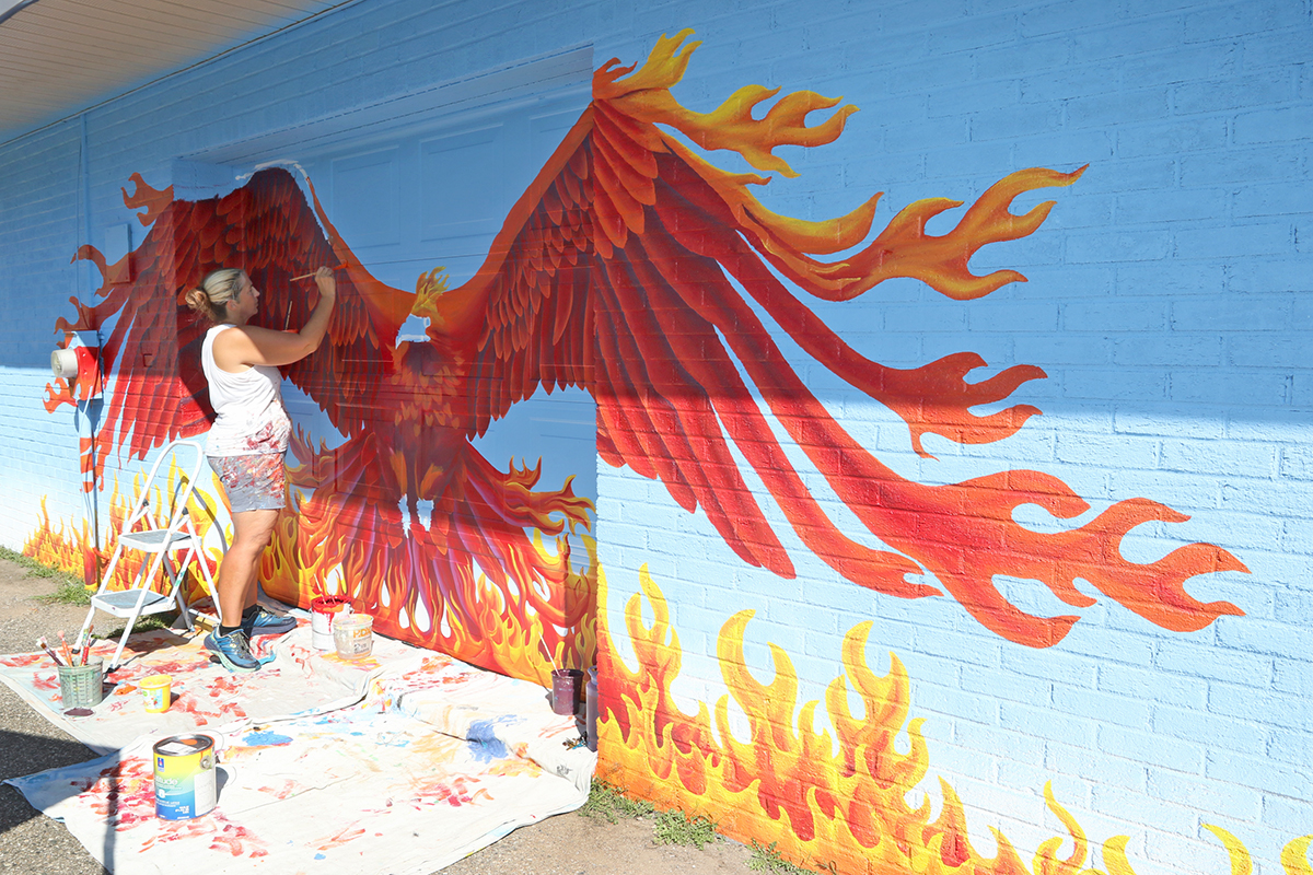 Leaving+her+mark.+Painting+a+phoenix+mural%2C+art+teacher+Jennifer+Ramirez+showcases+her+art.+Ramirez+was+honored+by+Madison+Heights+for+her+artwork+around+the+city.