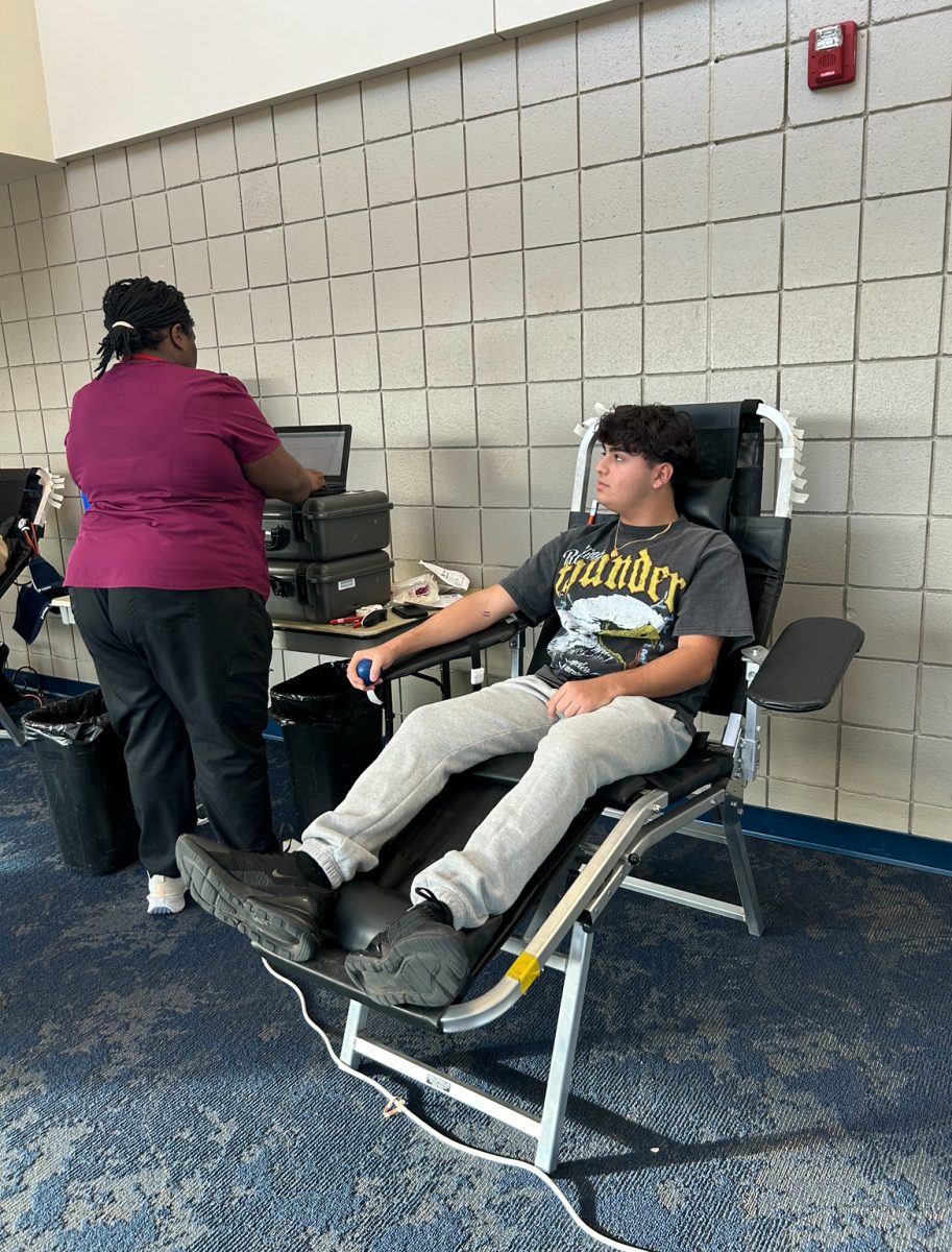 Need for blood. During the Key Club hosted blood drive, junior Julian Kinaya donates blood. “I donated blood because I thought  it might help somebody who needs it more than me,” said Kinaya. After donating, he was greeted by the staff and recovered relatively quickly. 

