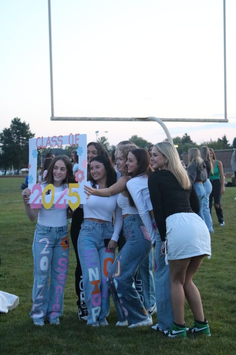 Seniors Alexandria Wood, Sarah Dotson, Sydney Gower, Aubrey Bowen, Bella Lechner and Guiliana Buffa pose behind a hand-crafted class of 2025 sign. They also matched with their personal painted jeans.