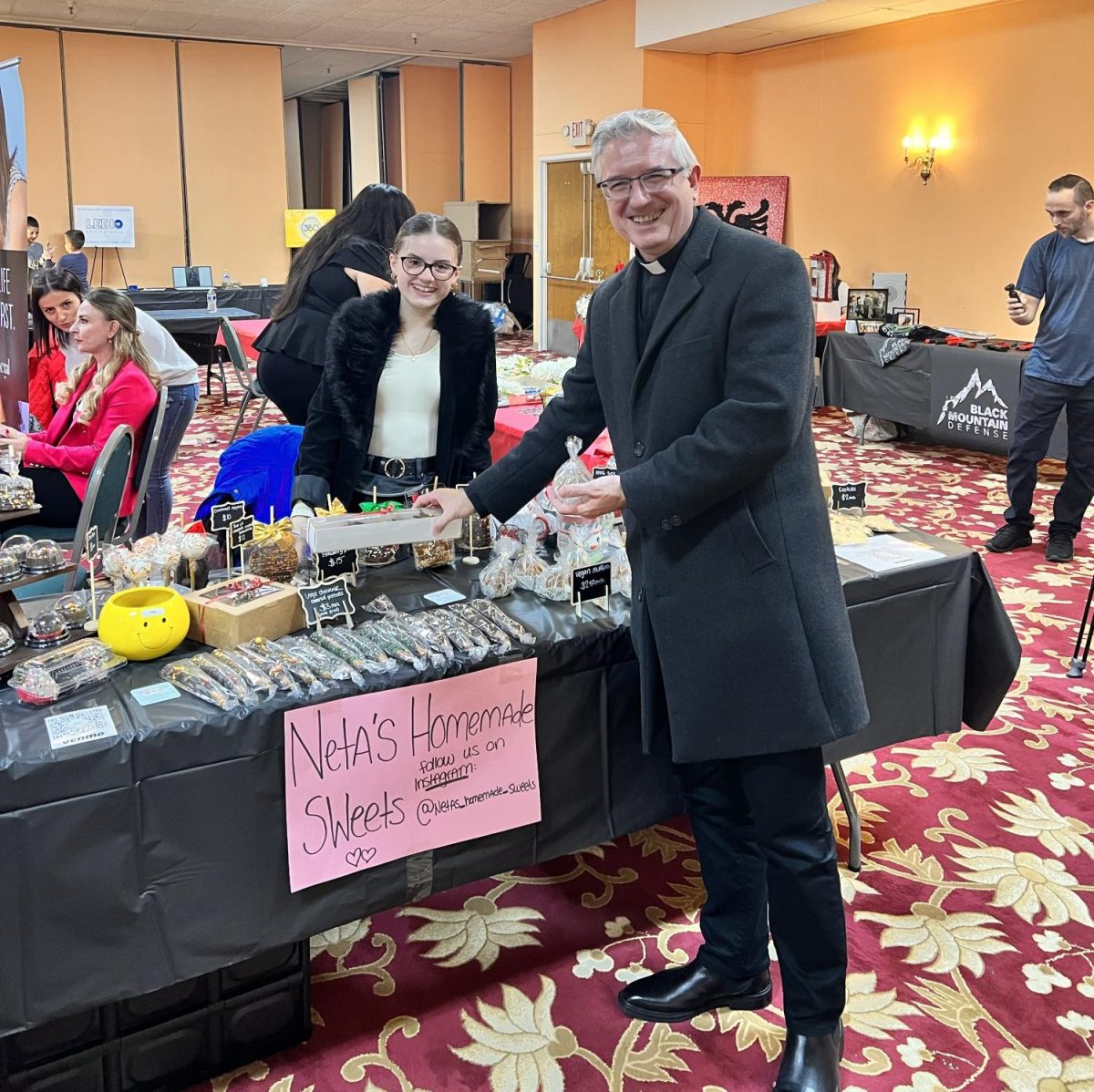 Displaying her baked goods Antoneta Gjonaj makes sales at a vendor show. Her bakery Neta’s Homemade Sweets has made thousands of dollars.