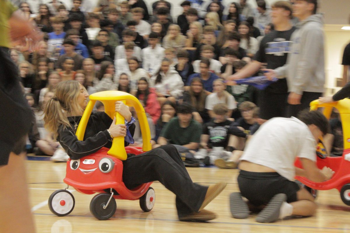  A license isn't needed to drive the toy car junior Katie MacKool was in during the pep assembly. “I did not expect it.[the toy cars they pulled out]” MacKool said, at first perplexed as to how she would approach the challenge she easily overcame and enjoyed coming in second place and taking away a cherished school memory.
