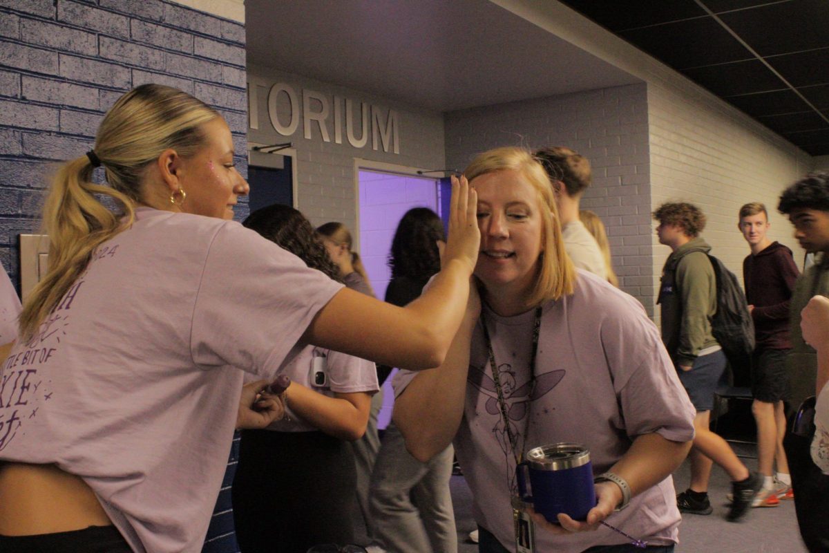  At the pep assembly science teacher Julia Sinnings rocks school spirit  “I think especially as a teacher it is important for me to be a role model,” Sinnings said. She wanted to show kids it's not uncool to show support for your school and the fun activities don't have to be reserved for games; it can boost morale and attitudes of students as well as teachers alike.
