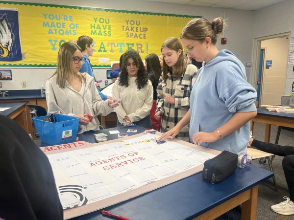 Key Club members creates decorations for Fall Rally. They created posters in the shape of magnifying glasses, case folders and more.