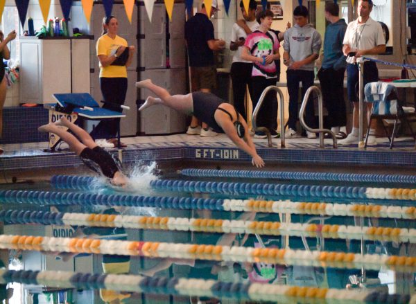 Sophomore Abigail Kelly dives into the water for her 100-meter butterfly. "It was definitely hard, but I told myself 'If I get through this, then I'll be good," she said.