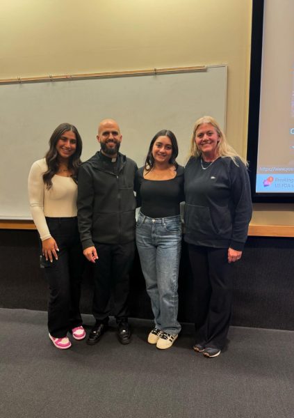 Club leaders senior Angelina Garmo and sophmore Alyssa Kasmikha, special guest Father Simon, and club advisor Jennifer Solomon meet for the Jesus loves you club. The club meets in the ECC or Solomon's room every other Friday after school