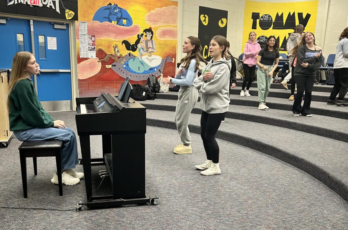 The students in Mrs. Holts 5th hour practice Christmas songs to prepare for their holiday concert. Sophomores Brooke Fortier and Vivian Catlin are in the front row of Mrs. Holt’s 5th hour and are practicing singing and dancing. 