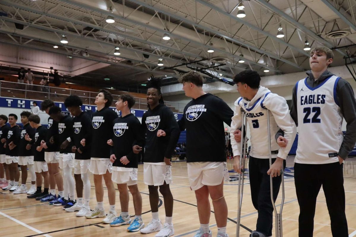 The varsity basketball team is lined up for the national anthem prior to their home opener on Tuesday, Nov. 26. “There were a lot of nerves and many guys were playing for the first time. You simply can’t win with that many team fouls,” senior Alexander Edgar said. The Eagles lost 70-54 against Roseville but look to bounce back in their upcoming matchups.  
