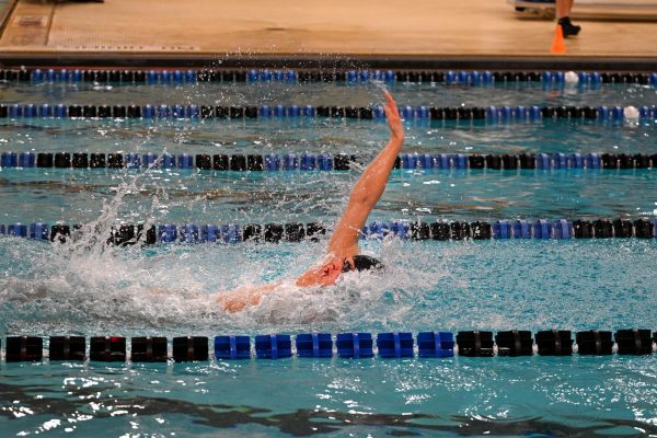While swimming back during a meet against Fraser high school, senior Simon Kristensen brings his hand back to continue the stroke. “Beating the record made me feel proud, the hardest part of breaking records was practicing more because that meant I had to wake up early for morning practices,” Kristensen said. He broke the records for 200 MR, 100 free, 100 back, 200 free and 500 free.
