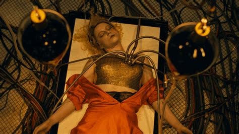 During one of the opening scenes of the movie, Jessie Buckley’s character is shocked back to life.
